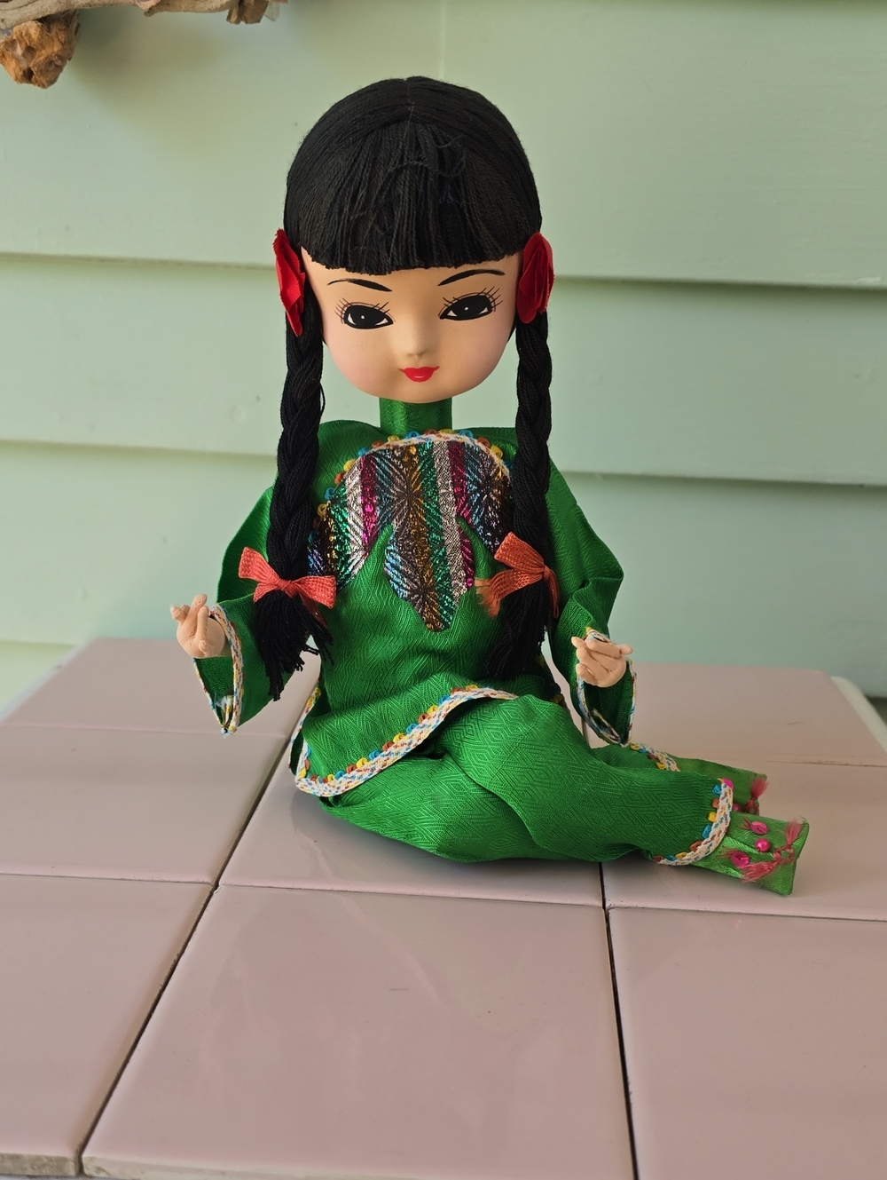 Vintage cloth doll with stockinette face in traditional Asian-style green silk c
